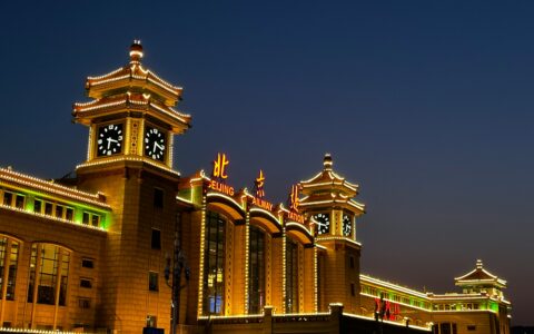a large building with a clock tower in front of it